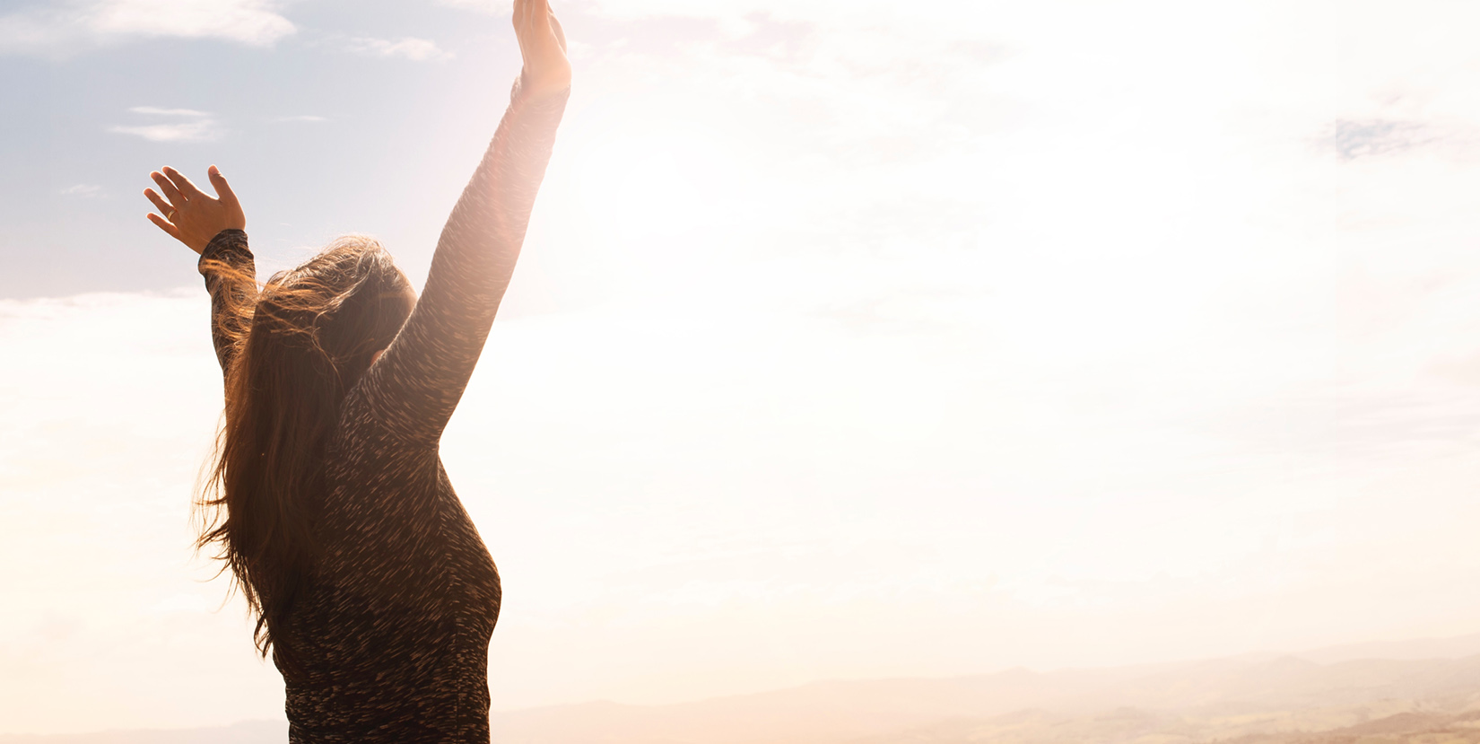 Woman raising her hands in freedom - In the “therapy” world, validation is the process of other’s confirming the validity of emotions, but many don't know how powerful and liberating it can be.
